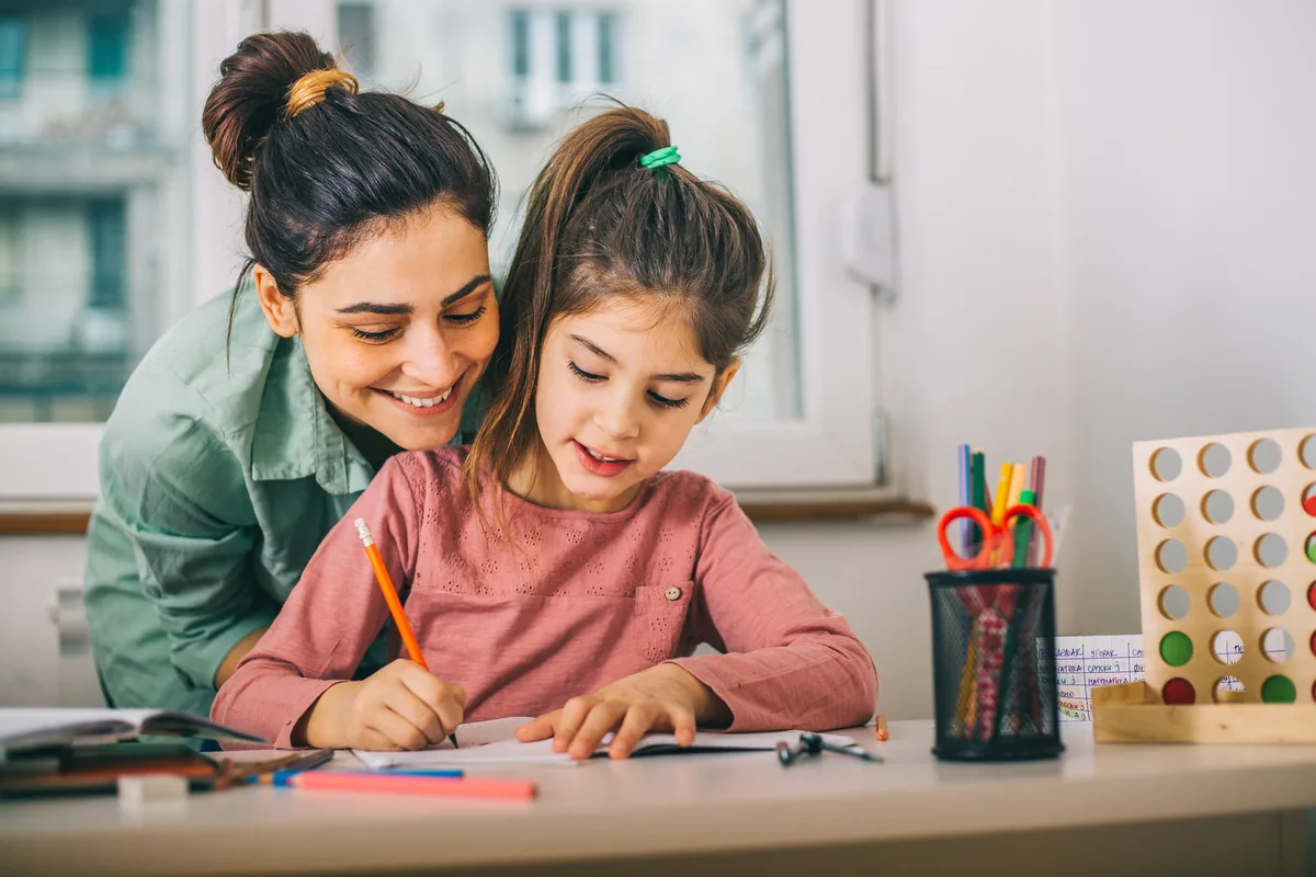Child building reasoning confidence with supportive one-to-one practice